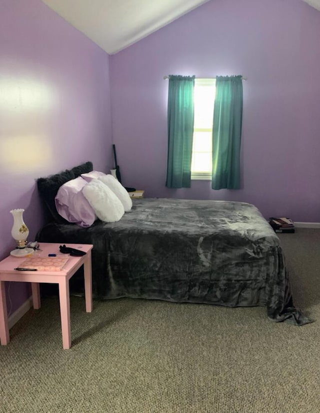 bedroom featuring carpet floors and lofted ceiling