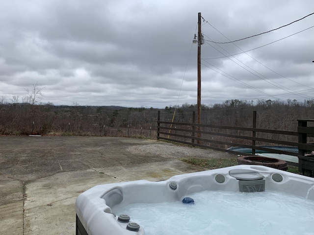 view of yard with fence and a hot tub