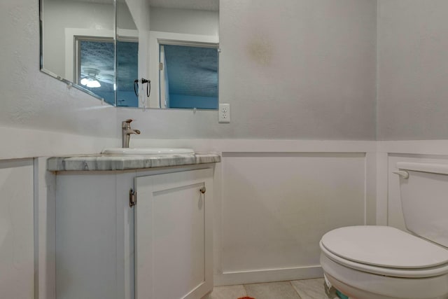 bathroom with tile patterned floors, vanity, and toilet