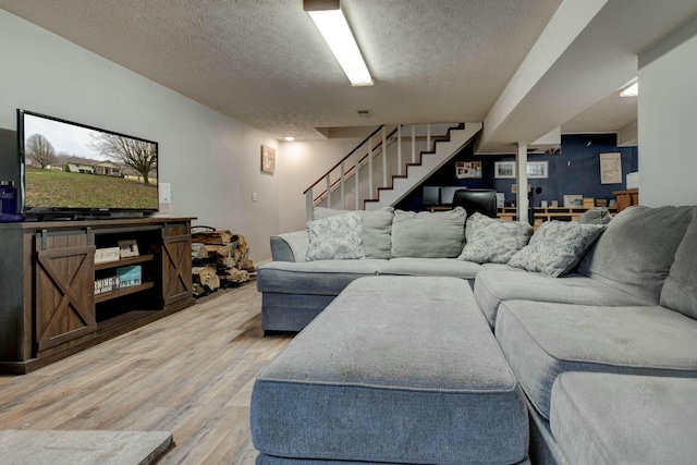 living room featuring hardwood / wood-style floors and a textured ceiling