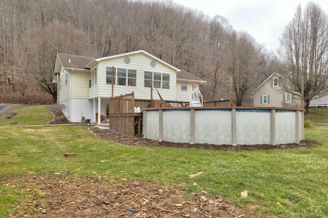 rear view of property featuring a yard