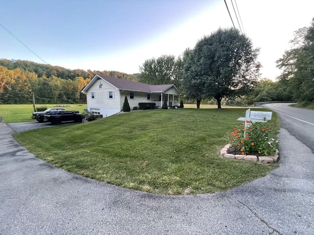 view of side of property with a lawn