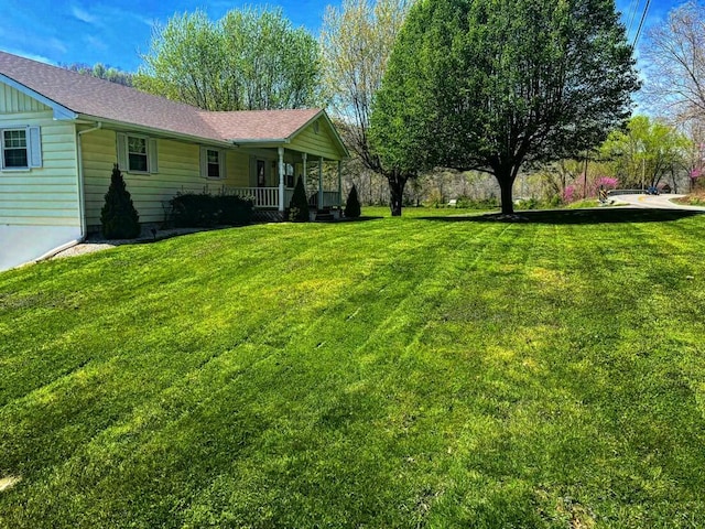 view of yard featuring covered porch