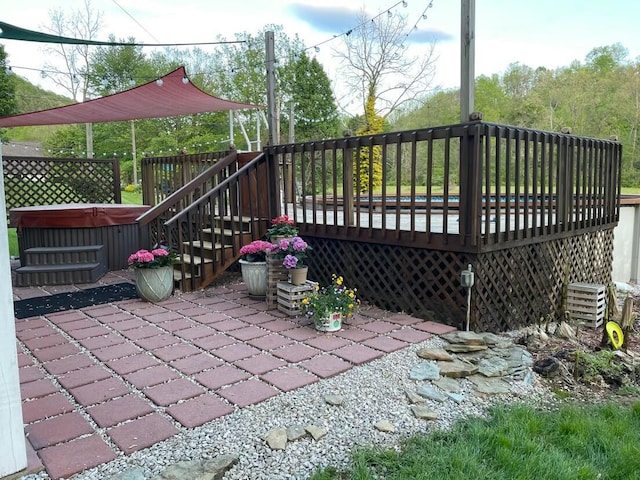 exterior space with a hot tub and a wooden deck