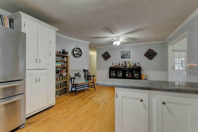 1695 Christy Creek Rd, Morehead, KY 40351 - kitchen featuring freestanding refrigerator, ornamental molding, a textured ceiling, a ceiling fan, and white cabinets