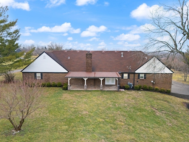 2940 Shakertown Rd, Danville, KY 40422 - rear view of house with a chimney, a yard, a metal roof, and brick siding