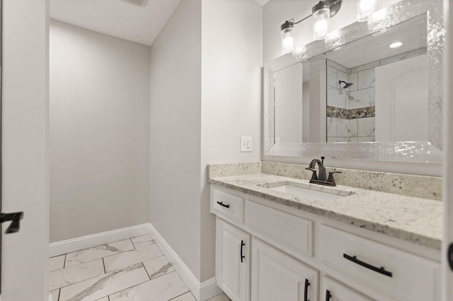 bathroom with vanity and a tile shower