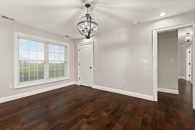 unfurnished dining area with a notable chandelier and dark hardwood / wood-style flooring