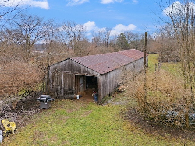 view of outdoor structure featuring a lawn