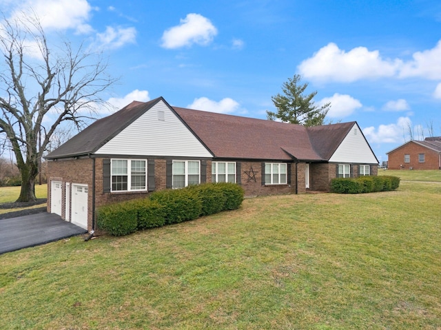 ranch-style home featuring a garage and a front lawn