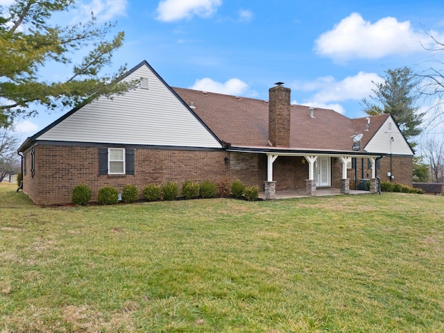 back of house featuring a yard and a patio