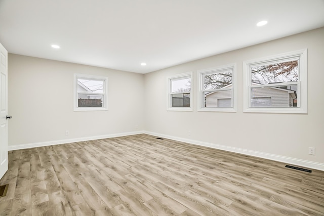 unfurnished room with light hardwood / wood-style floors