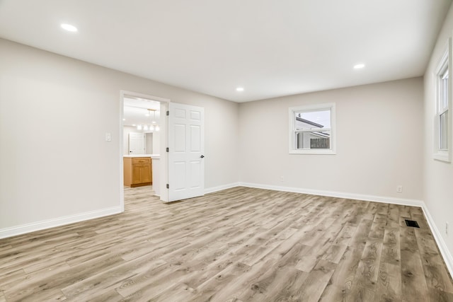 spare room featuring light hardwood / wood-style floors