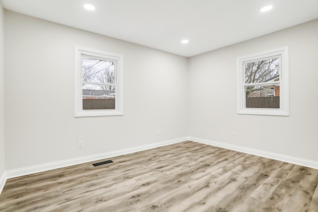 unfurnished room featuring light hardwood / wood-style flooring and plenty of natural light