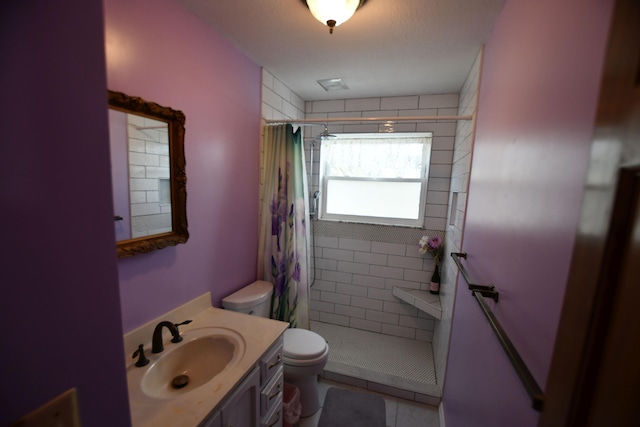 bathroom featuring vanity, curtained shower, tile patterned floors, and toilet