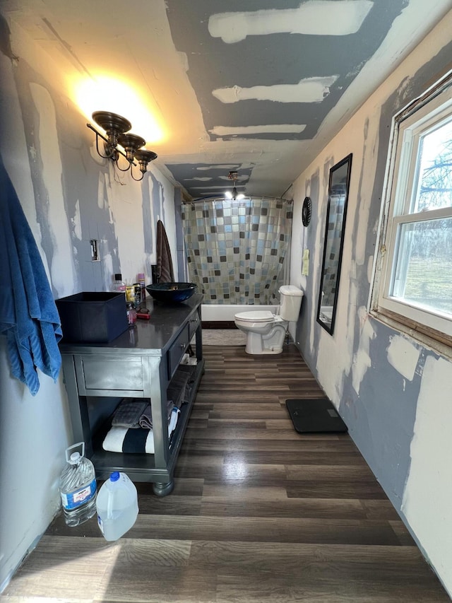 bathroom featuring hardwood / wood-style floors and toilet