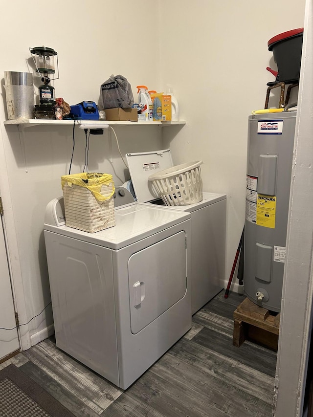 clothes washing area featuring dark hardwood / wood-style floors, washing machine and dryer, and electric water heater