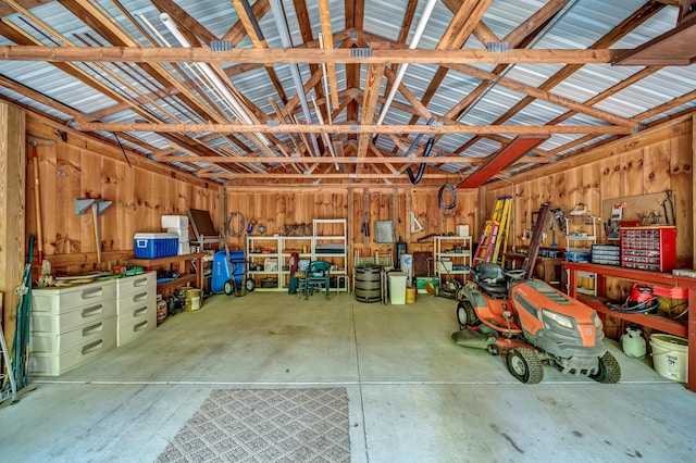 garage featuring a workshop area and metal wall