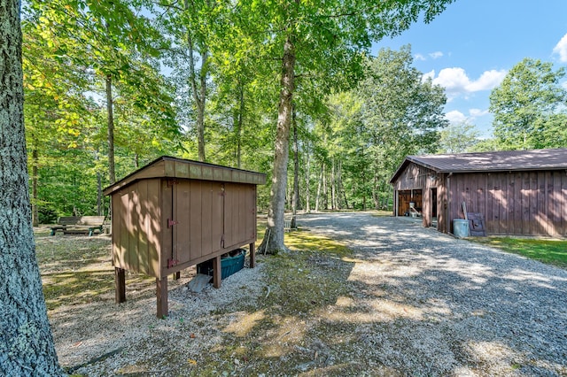 exterior space featuring gravel driveway and an outdoor structure