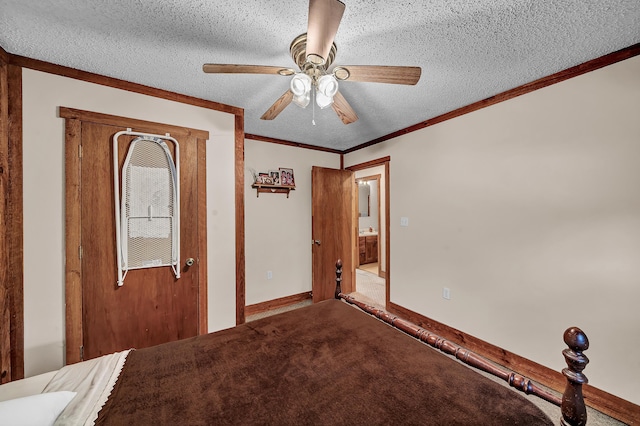 unfurnished bedroom with baseboards, a ceiling fan, ornamental molding, carpet, and a textured ceiling