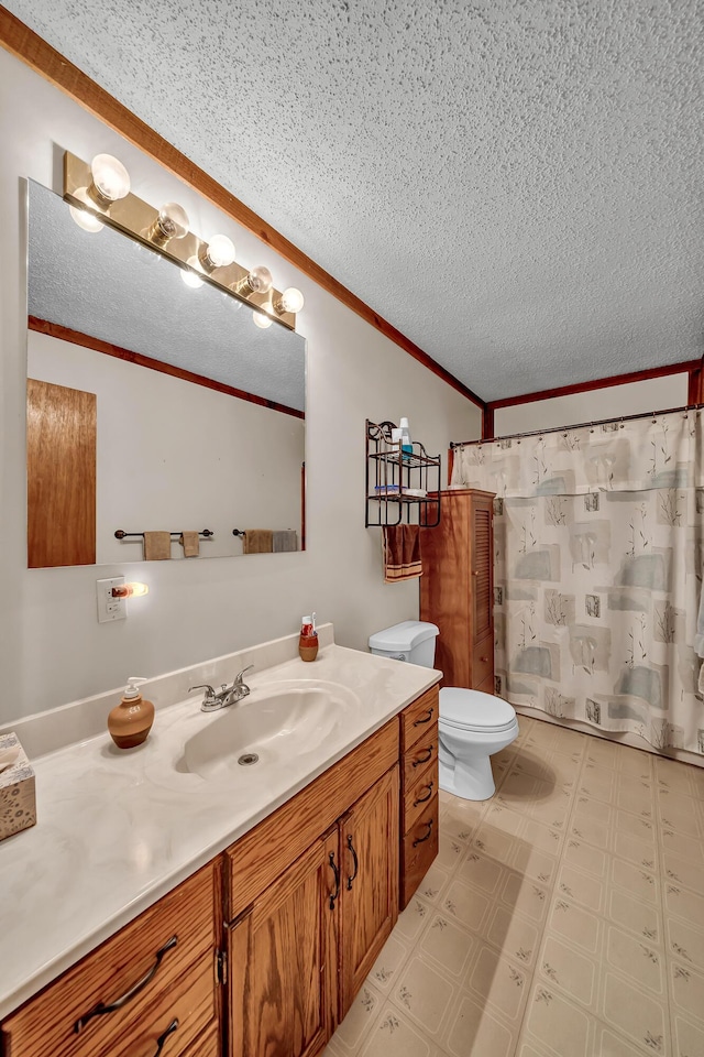 full bathroom featuring toilet, ornamental molding, tile patterned floors, a textured ceiling, and vanity