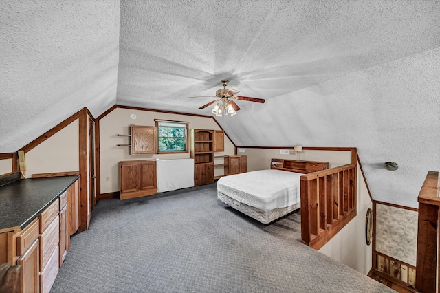 unfurnished bedroom featuring lofted ceiling, a textured ceiling, a ceiling fan, and carpet flooring