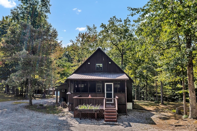 chalet / cabin featuring metal roof and a sunroom