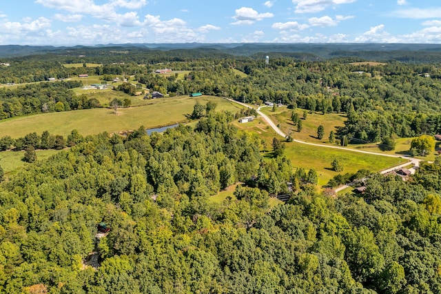 drone / aerial view with a wooded view