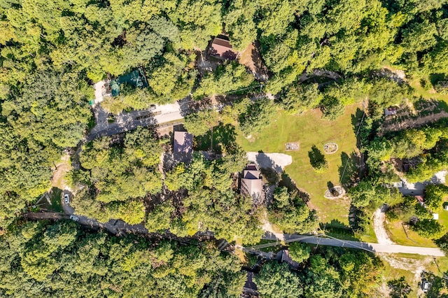 birds eye view of property featuring a view of trees