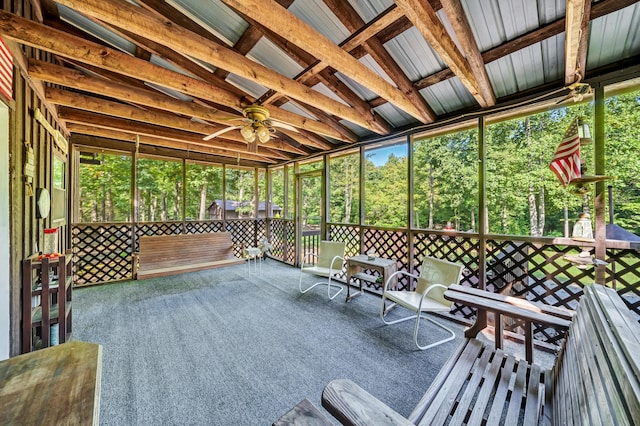 unfurnished sunroom with a ceiling fan