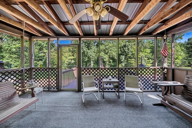 unfurnished sunroom featuring ceiling fan