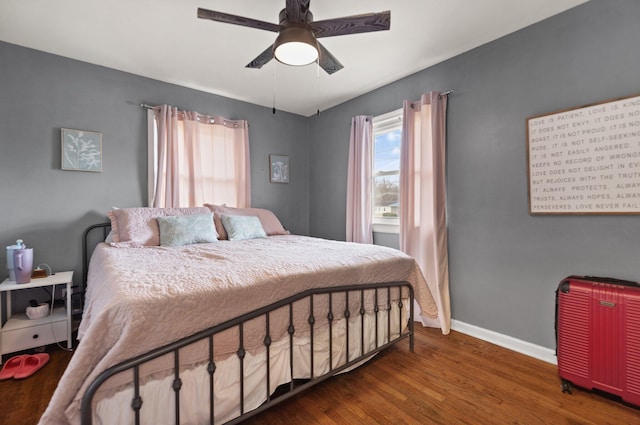 bedroom with dark wood-type flooring, radiator heating unit, and ceiling fan