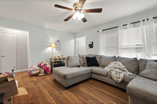 living room with dark wood-type flooring and ceiling fan