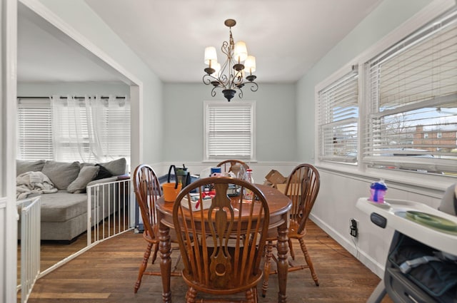 dining room featuring dark hardwood / wood-style flooring and a notable chandelier