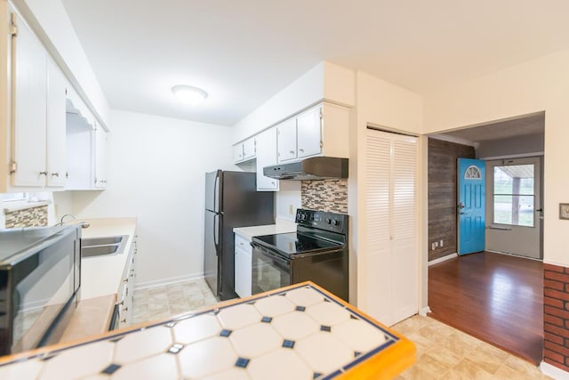 kitchen featuring white cabinetry, black range with electric stovetop, tasteful backsplash, and sink