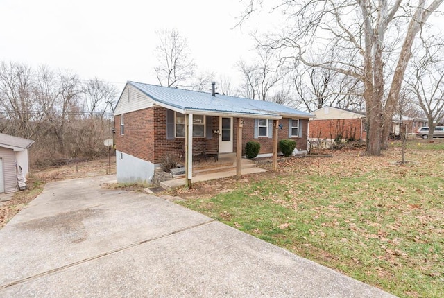 single story home with a front yard and covered porch