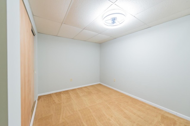 unfurnished room with carpet flooring and a paneled ceiling