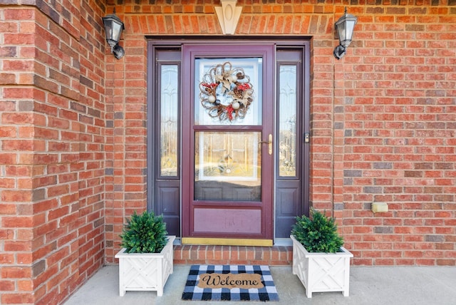 property entrance featuring brick siding