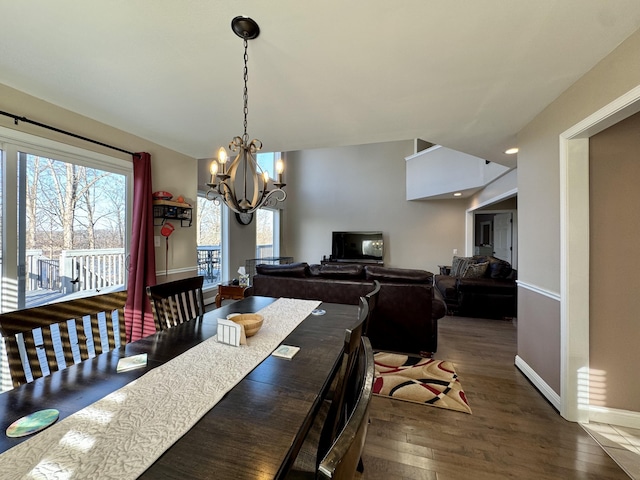 dining room with an inviting chandelier and dark wood-type flooring