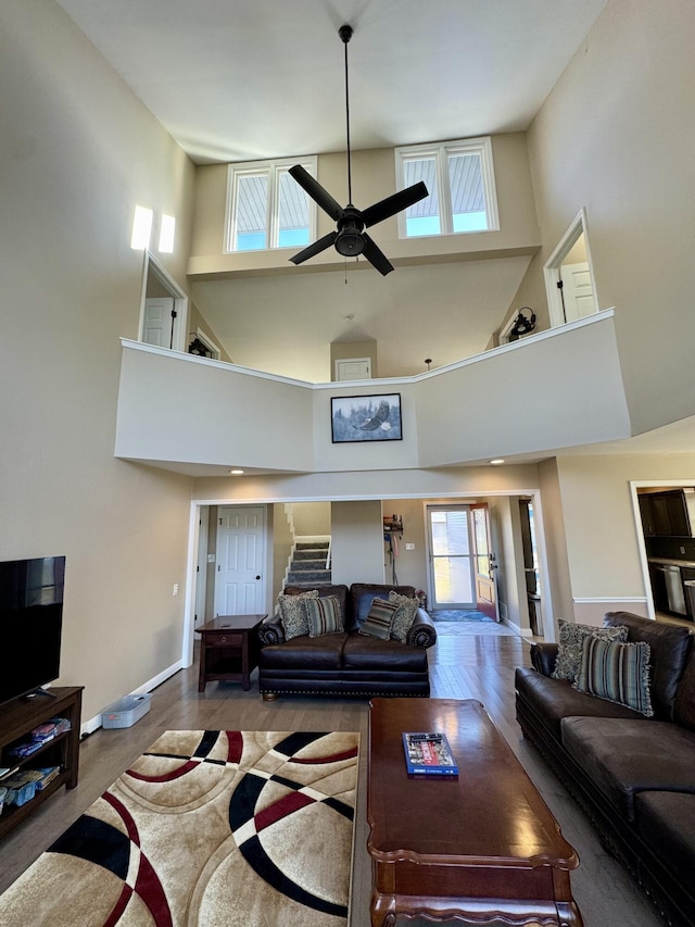 living room featuring wood-type flooring and ceiling fan