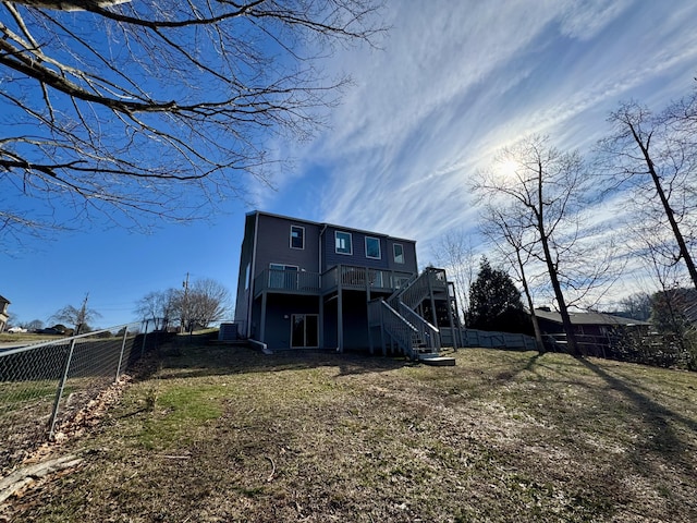 rear view of house featuring a wooden deck