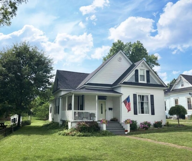 view of front of house with a front yard and a porch