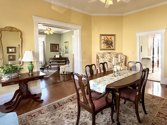 dining room with dark hardwood / wood-style flooring, ornamental molding, and ceiling fan