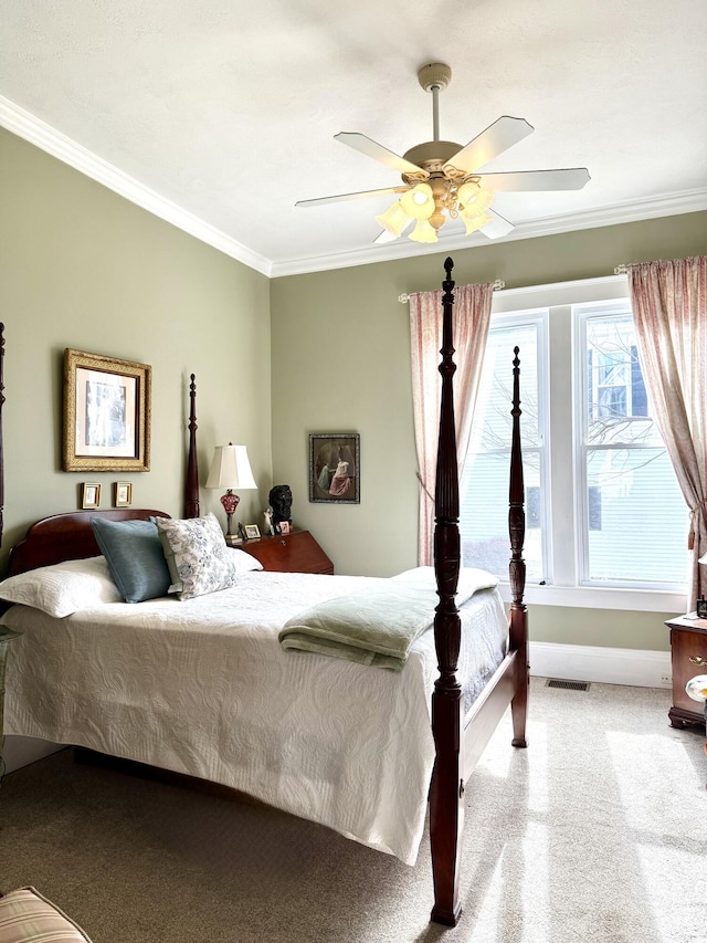 bedroom with crown molding, ceiling fan, and light carpet