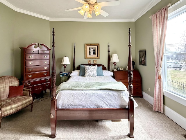 carpeted bedroom featuring ceiling fan and ornamental molding