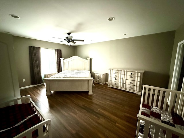 bedroom with dark hardwood / wood-style floors and ceiling fan