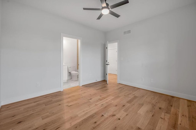 unfurnished bedroom featuring ensuite bathroom, ceiling fan, and light wood-type flooring