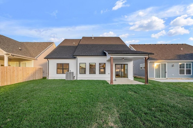 back of property with central AC, a lawn, a patio, and ceiling fan