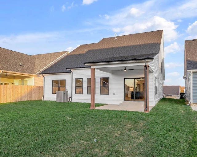 back of property featuring ceiling fan, a patio, and a lawn