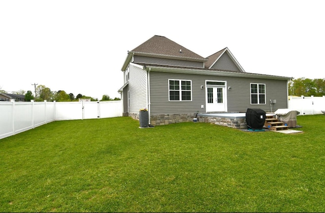 back of house featuring a patio and a lawn